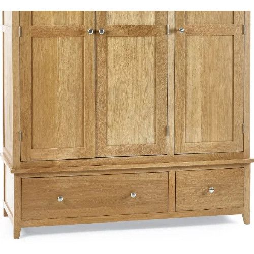 Close-up view of the Mallory 3 Door Wardrobe, showing its light oak wood texture, panelled doors, and silver knob hardware.