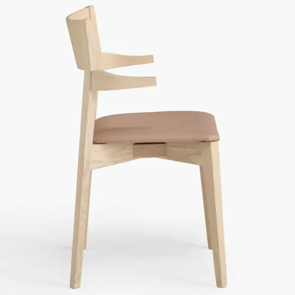 Side view of the Miss Armchair, showcasing its light wooden frame and soft tan upholstered seat on a white background.