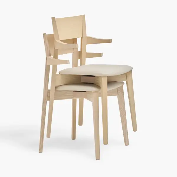 Profile view of two stackable Miss Armchairs featuring a light wood frame and cushioned cream upholstery.