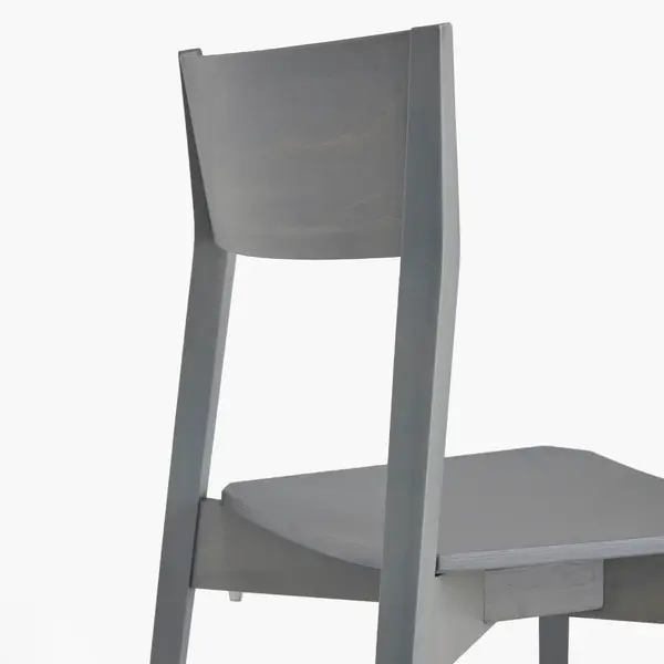 Close-up of the Miss W side chair, highlighting the clean, grey wooden backrest and sturdy frame construction.