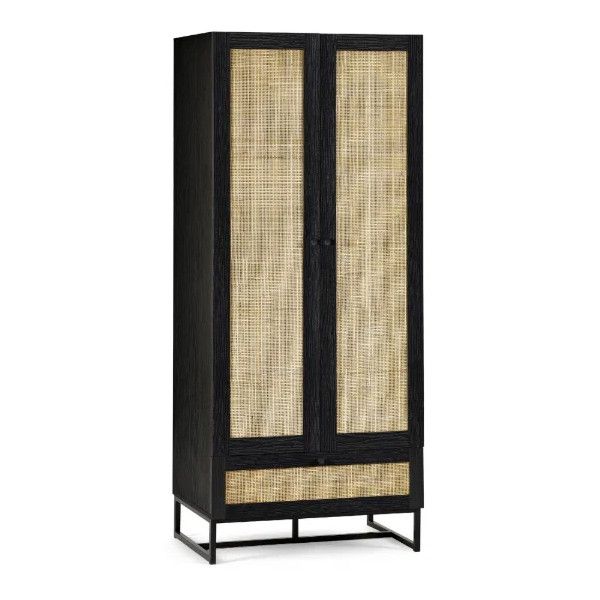 Studio shot of a black Padstow wardrobe displaying woven rattan doors and a base drawer over a minimalist metal frame.