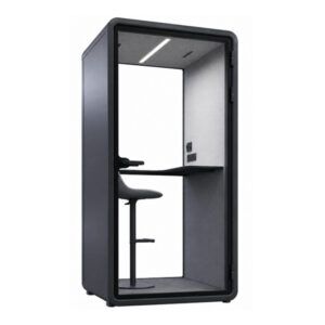 Isla Side Chair: black upholstered seat and back on a wooden frame, shown in a modern office pod setting.
