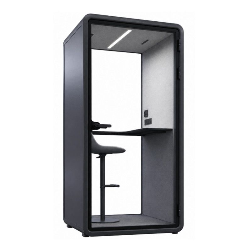 Isla Side Chair: black upholstered seat and back on a wooden frame, shown in a modern office pod setting.