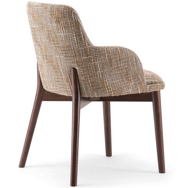 Rear view of the Celine Armchair showing textured beige upholstery and dark wooden legs.