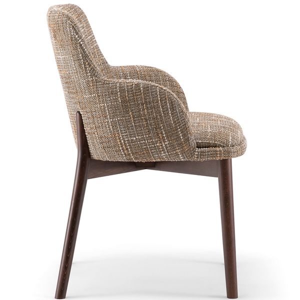 Side profile of the Celine Armchair with textured beige upholstery and tapered dark wood legs