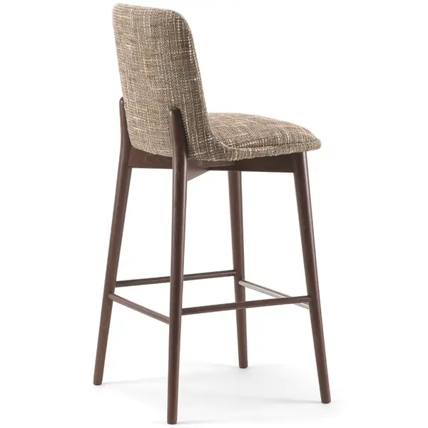 Celine Barstool viewed from a rear three-quarter angle, highlighting its textured taupe upholstered backrest and dark wooden legs.