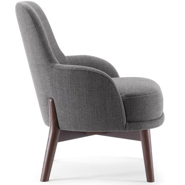 Profile view of the Celine Lounge Chair in grey fabric with a curved back and tapered wooden legs